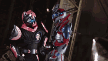 two robots are standing next to each other and one has a belt with the number 20 on it