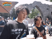 a man wearing a shirt that says kiss on it