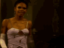 a woman wearing a purple dress and white gloves