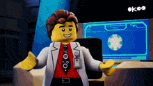 a lego man in a lab coat and tie stands in front of a computer monitor