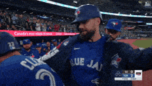 blue jays player number 22 is being hugged by another player