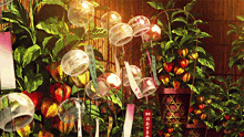 a bunch of wind chimes hanging from a fence with a sign that says ' i love you ' on it