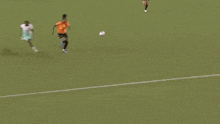 a soccer player in an orange shirt with the number 4 on it