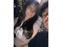 a boy and a girl are posing for a picture and the girl is wearing a shirt that says ' nike ' on it