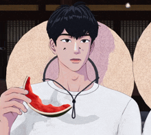 a man holding a slice of watermelon in his hand