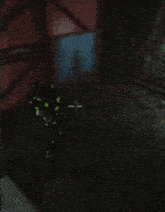a video game is being played in a dark room with a red case on a table
