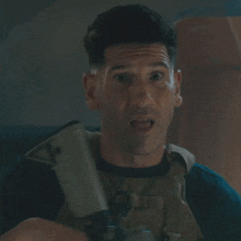 a man is holding a gun with a red light coming out of his mouth