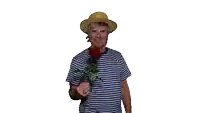 a man in a striped shirt and hat is holding a red rose