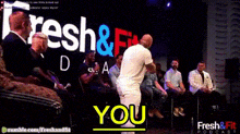a group of people are sitting in front of a sign that says fresh & fit podcast