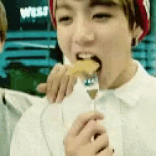 a young boy is eating something with a fork .