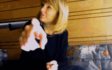 a woman sitting on a couch holding a piece of paper in her hand