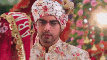 a bride and groom are standing next to each other at a wedding . the groom is wearing a turban .