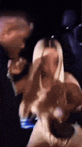 a blurry picture of a man and woman dancing in a dark room