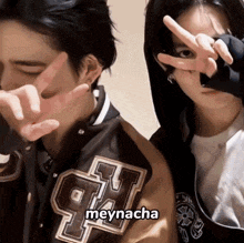 a man and a woman are making a peace sign with their hands and the name meynacha is on the bottom