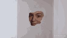 a person is painting a woman 's face with a brush and the words made in animatica are visible