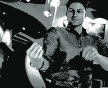 a black and white photo of a man in a button up shirt