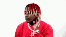 a man wearing a red shirt that says sailing team on it