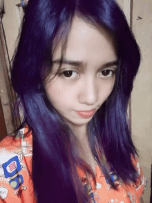 a girl with purple hair is wearing an orange shirt that says ' do ' on the front