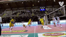 a volleyball game is being played in a stadium with advertisements for del monte quality and c.c.l.