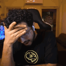 a man in a black shirt with a yellow brain on it