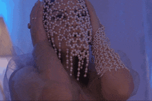 a naked woman is looking at herself in a mirror with a veil on her face