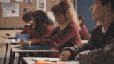 a group of students are in a classroom with the words son of a grifch on the wall