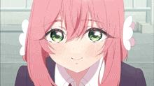 a girl with pink hair and green eyes is smiling for the camera