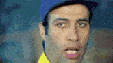 a man wearing a blue hat and a yellow shirt