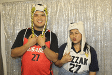 a man wearing a usade jersey and a woman wearing a grizzly jersey