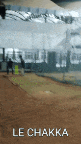 a blurred image of a baseball field with the words le chakka written on the bottom