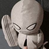 a stuffed toy with a pencil in its mouth