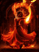 a woman in a red dress is dancing with a fire ring around her .