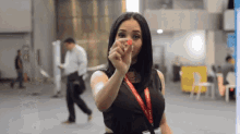 a woman with a lanyard around her neck that says ' coca cola '