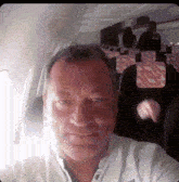 a man taking a selfie on an airplane with a zebra print seat