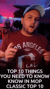 a man wearing a los angeles shirt and a hat is talking about things you need to know in mop classic top 10