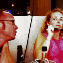 a man and a woman are looking at each other in a pixelated image