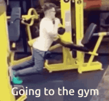 a man is kneeling on a machine in a gym with the words going to the gym written on the bottom .