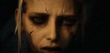 a close up of a woman 's face with a metal mask on her face