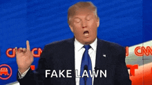 donald trump is wearing a suit and tie and making a funny face while giving a speech .