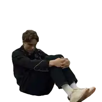 a man sitting on the floor with his legs crossed