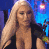 a woman with a very large breast is sitting in front of a microphone .