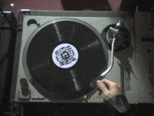 a person is playing a record on a turntable that has a label that says ' aespagifs '