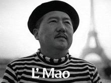 a man wearing a hat and a striped shirt with l mao written on the front