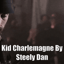 a man with a beard wearing a hat with the words " kid charlemagne by steely dan " on the bottom