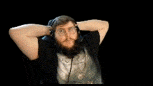 a man with a beard is sitting in a chair making a funny face .