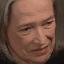a close up of a woman 's face with a slight smile