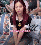 a girl with red hair is sitting on a floral couch with the words girls will be girls above her