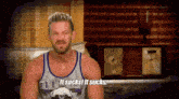 a man wearing a tank top that says it sucks it sucks