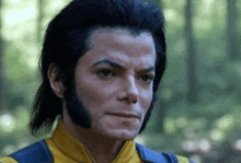 a man with long black hair and a beard is wearing a yellow and blue vest