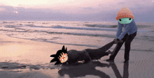 a person pulling another person on the beach with a cartoon character in the background